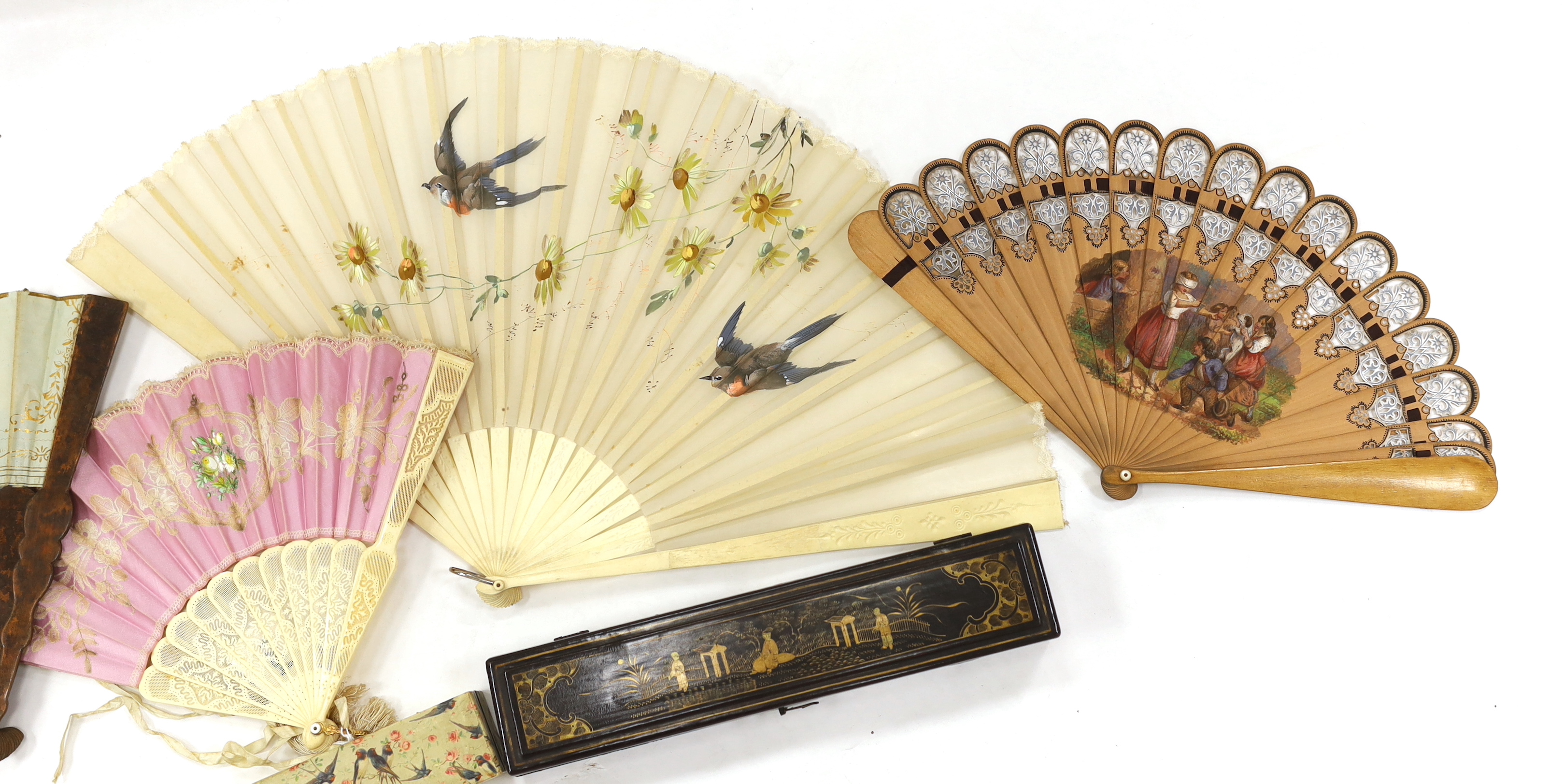 A Chinese lacquer fan box and a paper covered fan box, two Victorian fans painted with scenes of children playing, a gauze painted fan and another with bobbin lace appliqué, lacquer box 32cm wide x 4.5cm high